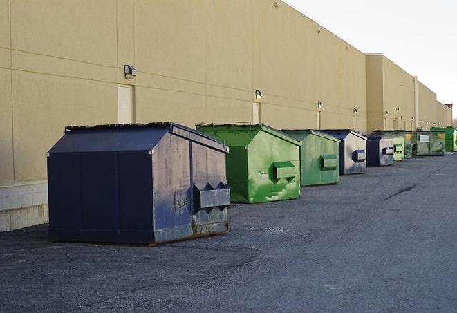 a stack of yellow construction dumpsters on a job site in Corcoran